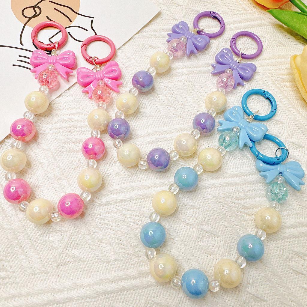 Handmade candy-colored bow bead pendant phone case chain for female students - beaded hand-held jewelry and bag accessory.