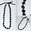 Collana di noci di kukui - Laurea Classe 2023 - Ghirlanda di noci con perline nere e fiocco - Regalo di laurea - Accessorio per feste