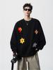 Trendig svart herrtröja med blombroderi och kraftig rund hals - höstens avslappnade lösa passform