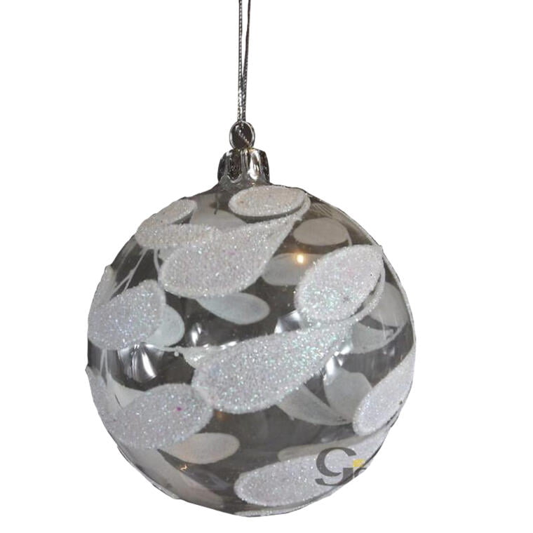 Transparent glass bauble with white leaf-shaped decoration