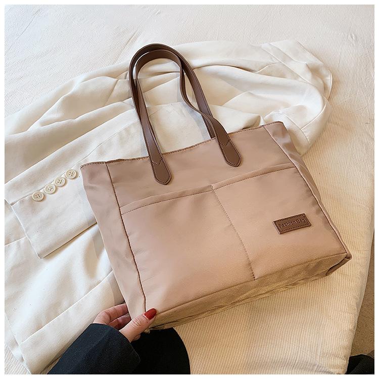 

Trend splicing personalized casual bag women s 2025 new large-capacity handbag canvas texture shoulder tote bag хаки