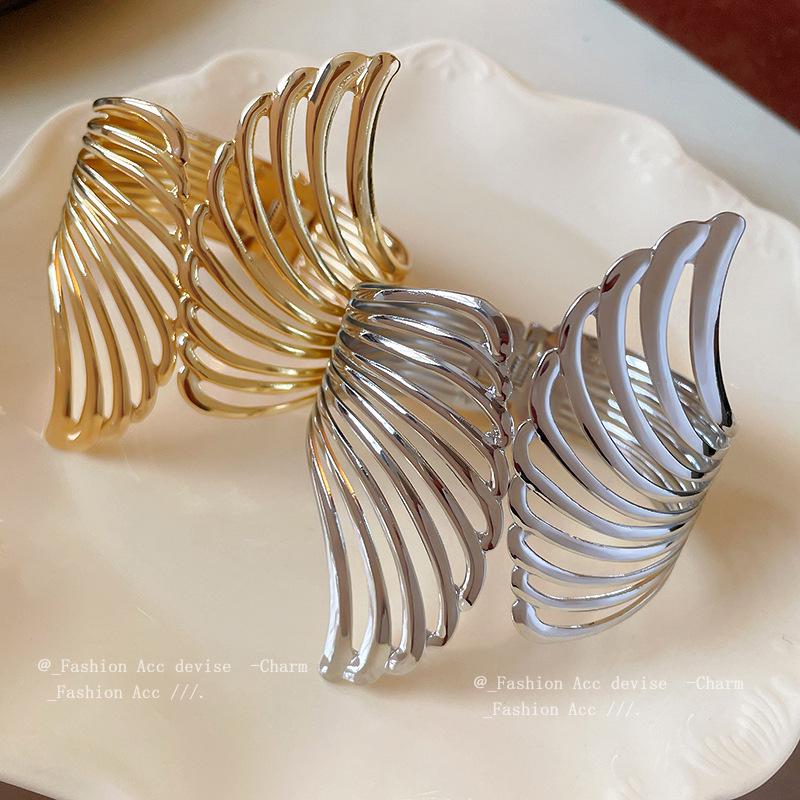 

European & American Winged Hollow Bangle - High-End Trendy Statement Bracelet for Women