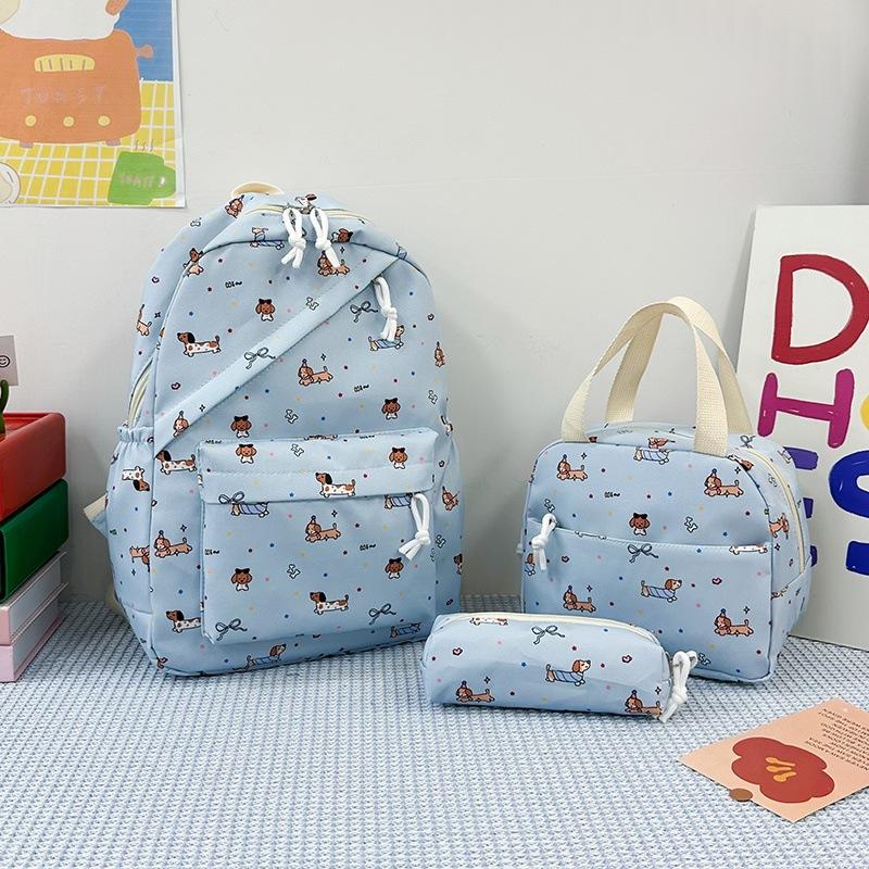 New cartoon printed women's schoolbag, junior high school and primary school students reduce the burden of three-piece backpack, large-capacity