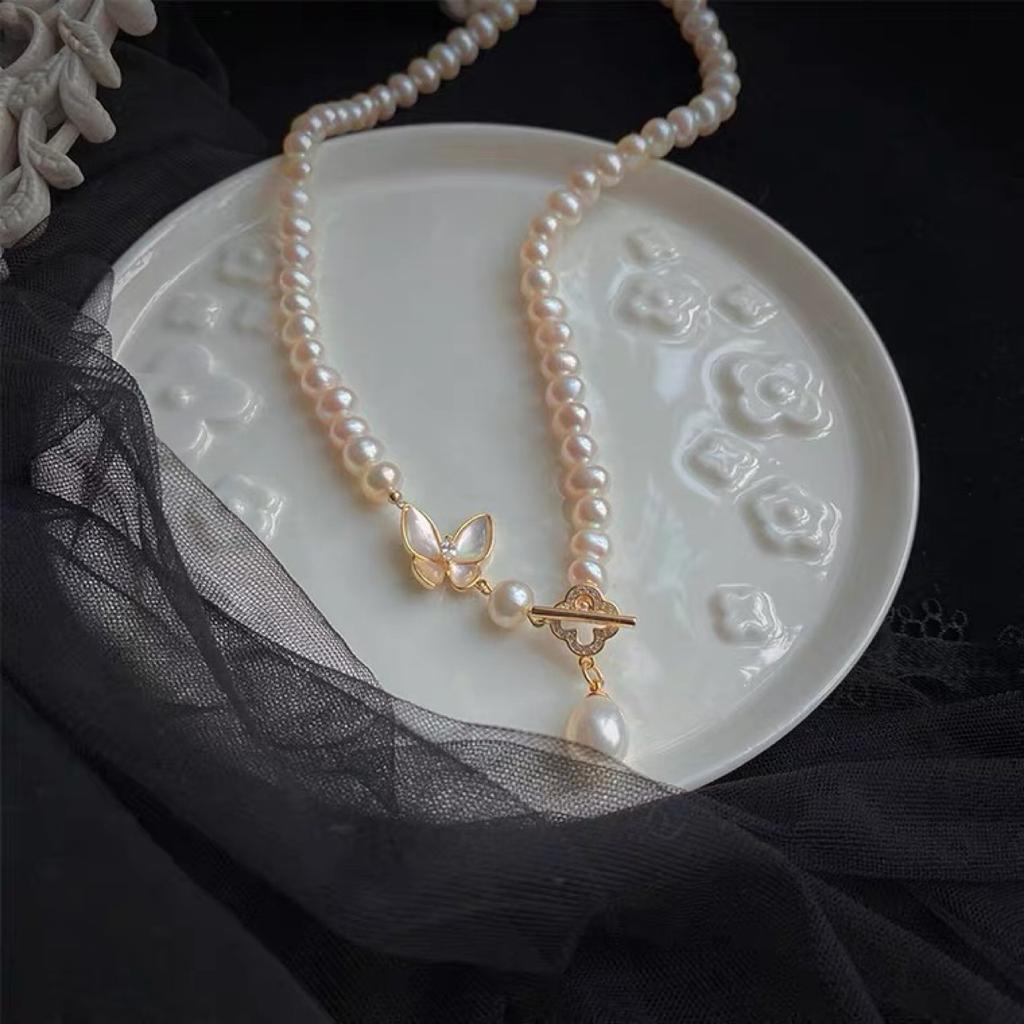 Designer-style necklace featuring natural freshwater pearls and a near-round, mother-of-pearl butterfly pendant 14k Gold-plated Sweet necklace with a