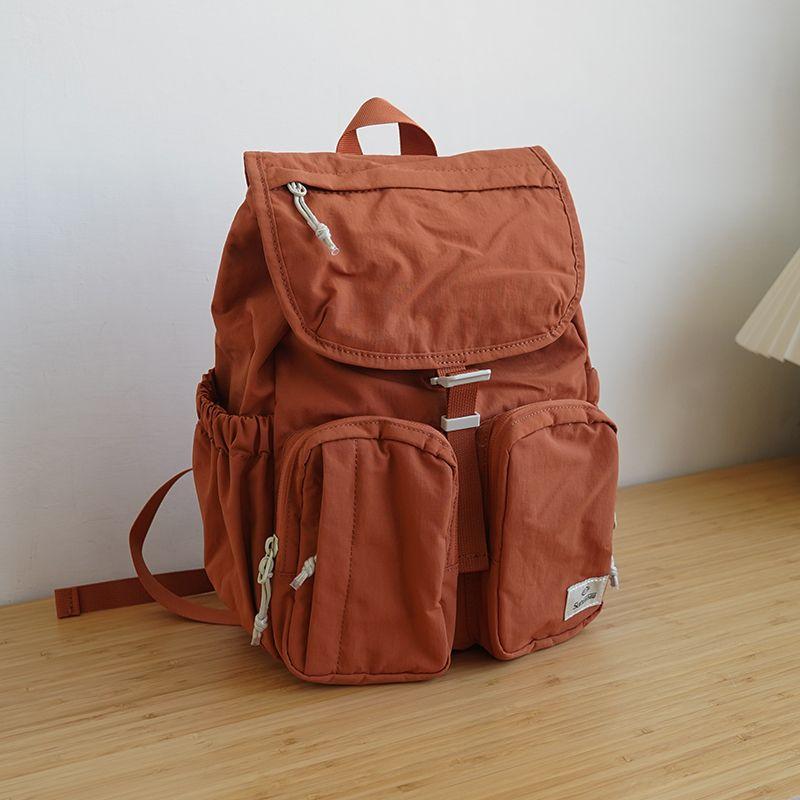 

Lightweight Backpack Minimalist Outdoor Casual Backpack Genuine Goods Waterproof Nylon Travel Mountaineering Bag Computer Bag Small size Orange Small pendant