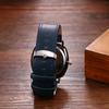 Men's waterproof and rainproof wristwatch with a round dial, quartz movement, numeral dial, blue strap, and black case. A simple accessory perfect