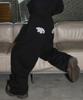 Seulliggeullou Angel Applique Curved Sweatpants [Black]
