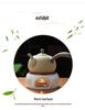 White Porcelain Tea Set with Black Ceramic Stove and Candle Base