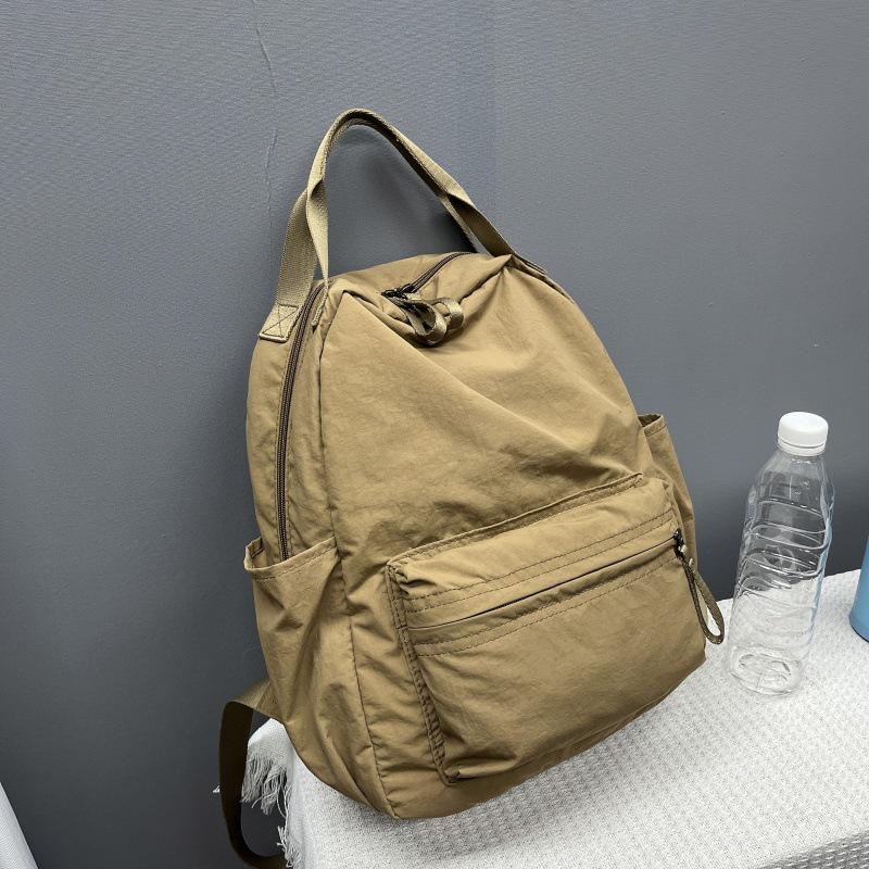 

2025 Универсальный водонепроницаемый нейлоновый рюкзак – Легкая дорожная сумка для мужчин и женщин 29x12x32 хаки