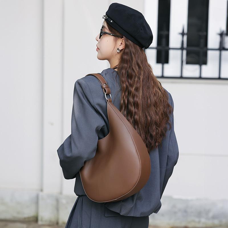 New niche design special-shaped crescent bag, semi-round bag, one shoulder and underarm women's bag, leather messenger tote bag.
