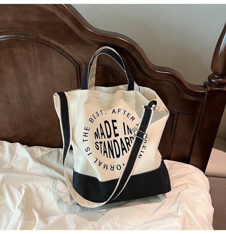 

Niche casual canvas bag women s spring new student class commuting shoulder bag trendy messenger bag чорний