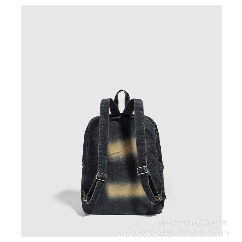 Retro-Rucksack aus wassergewaschenem Denim mit einem Nischendesign, mit einer Schleife und einem großen Fassungsvermögen für den Arbeitsweg.
