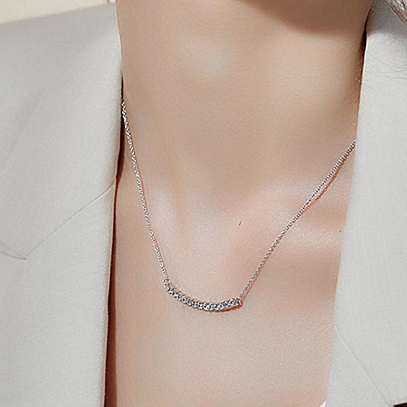 Curved smile pendant necklace, set with zircon stones