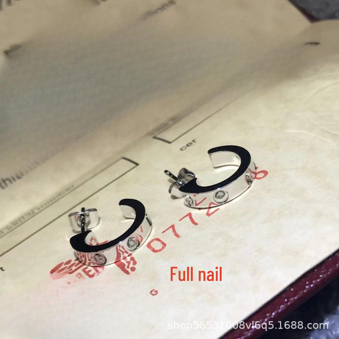 

Позолочені сережки C-подібної форми з діамантовими вставками та гвинтовим дизайном