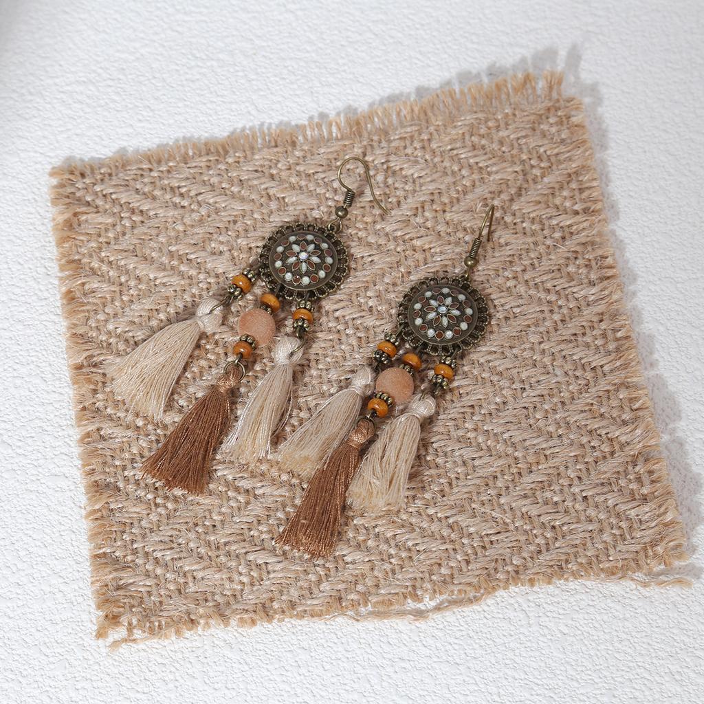 Retro ethnic style woven feathers long fringed earrings, bohemian high-end hollow rice bead earrings
