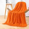Orange knitted throw blanket for model homes, suitable for use as a sofa or bed throw, for furniture stores and home showrooms as a soft decoration