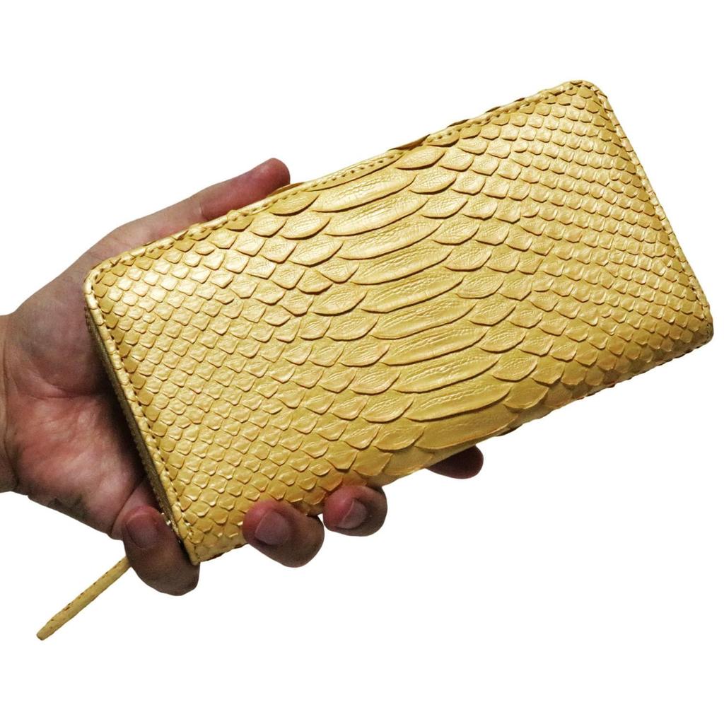 This gold long wallet for men and women is made from a single piece of genuine snakeskin leather. It features a round zipper, a coin purse, and card