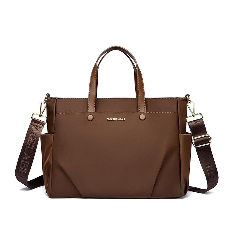 A Laptop Bag, A Lady Carrying A Business Briefcase and Slung A Commuter Tote Bag Across Her Shoulder