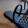 Fishing net niche simple design sense versatile black woven outer wear hollow flat bottom cool slippers women
