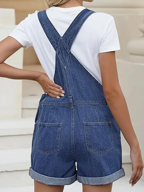 Damskie sprane niebieskie dżinsowe ogrodniczki z regulowanymi ramiączkami i podwiniętymi nogawkami