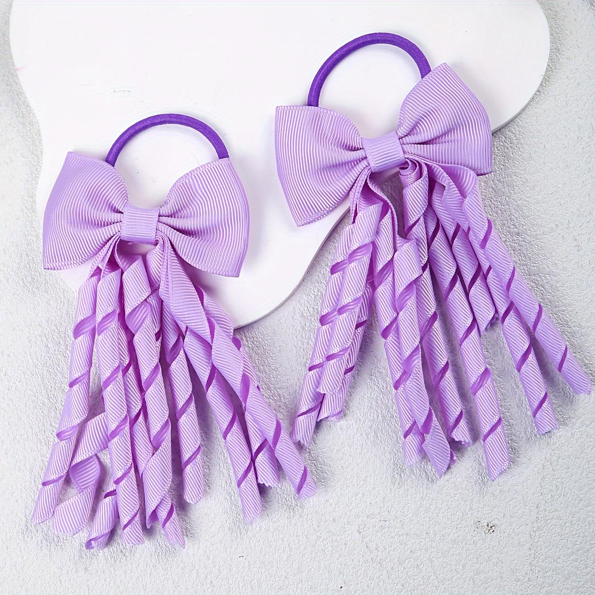 

Two Hair Accessories for Girls, Featuring Bows, Curls, Tassels, And Hair Ties for Cheerleaders. фіолетовий
