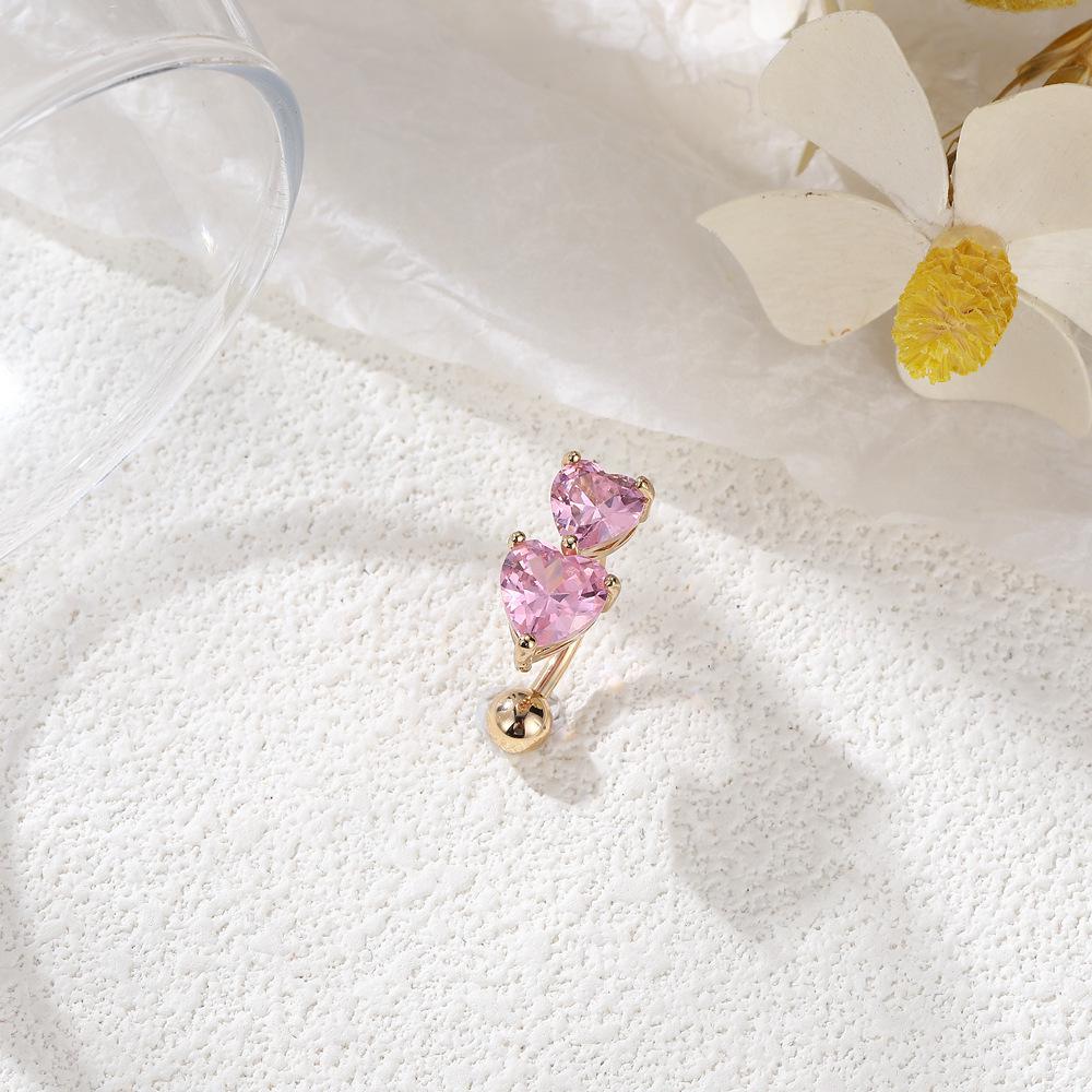 

Популярный пирсинг пупка в виде двойного сердца со стразами — европейский и американский стиль