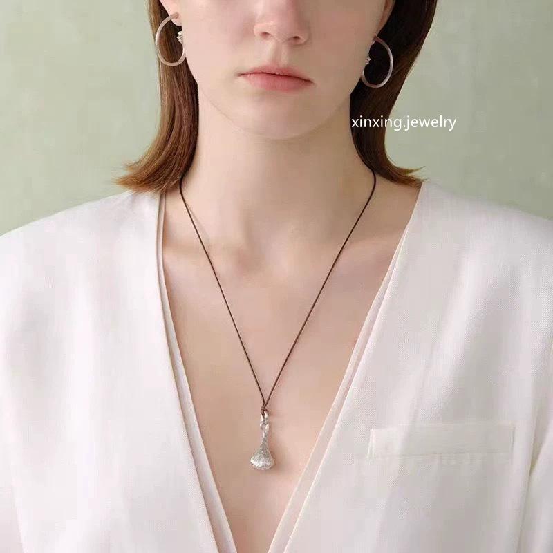 

Retro Lotus Pod Pendant Necklace: Minimalist, Versatile, Unisex Fashion. Brown Cord