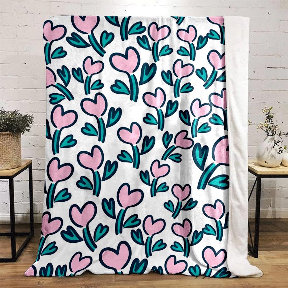 Pink heart-shaped flowers with teal leaves on a white background. for all seasons blanket lunch break throw gift