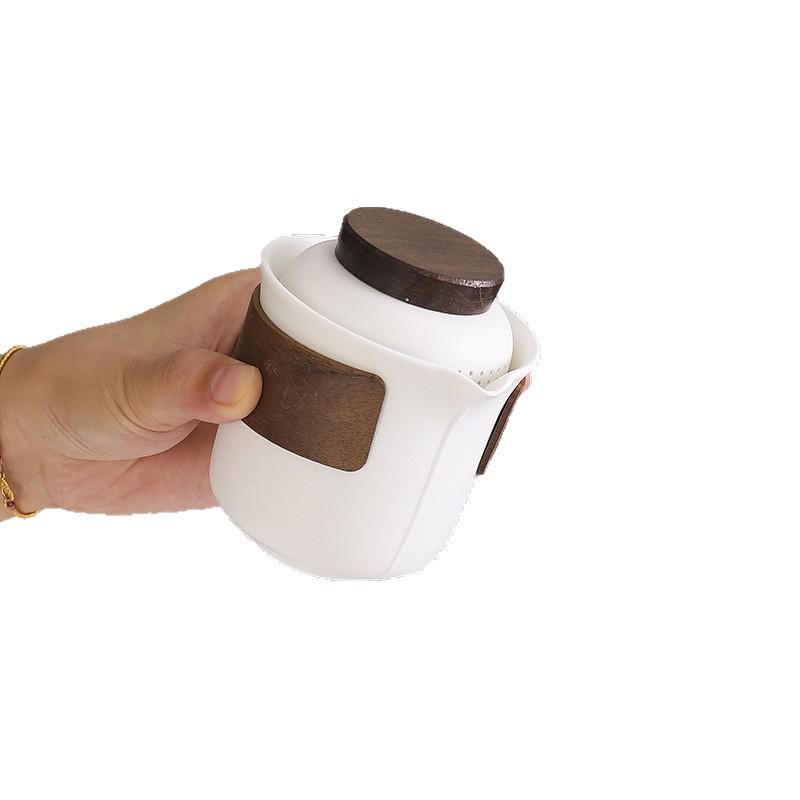 Portable Travel Tea Set: Teapot, Four Cups, and Storage Bag for Outdoor Camping.