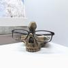 Skull Head Sculpture Eyeglass Holder Resins Glasses Stand Spectacle Display Rack for Desk Decoration and Home Office Use