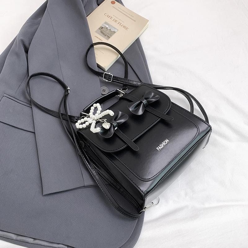 South Korea solid color college style commuter backpack women 2025 new trend bow portable shoulder messenger bag