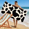 Serviette imprimé vache noir et beige Un incontournable pour les voyages à la plage