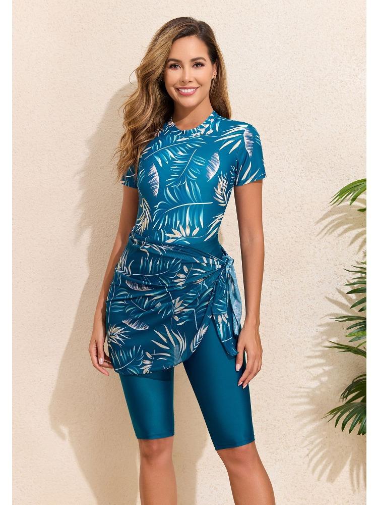 Bikini a tre pezzi alla moda con stampa a foglie, cerniera, gonna annodata e pantaloncini per la spiaggia estiva