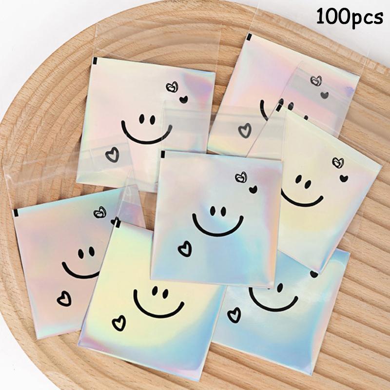 

100 шт. Симпатичные улыбающиеся лица самоклеящиеся пакеты лазерный прозрачный пакет для печенья пакеты для упаковки печенья день рождения вечеринка детский душ 7x7cm