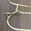 18K Gold-Plated Snake Bone Chain Necklace with Cross Bow Pendant