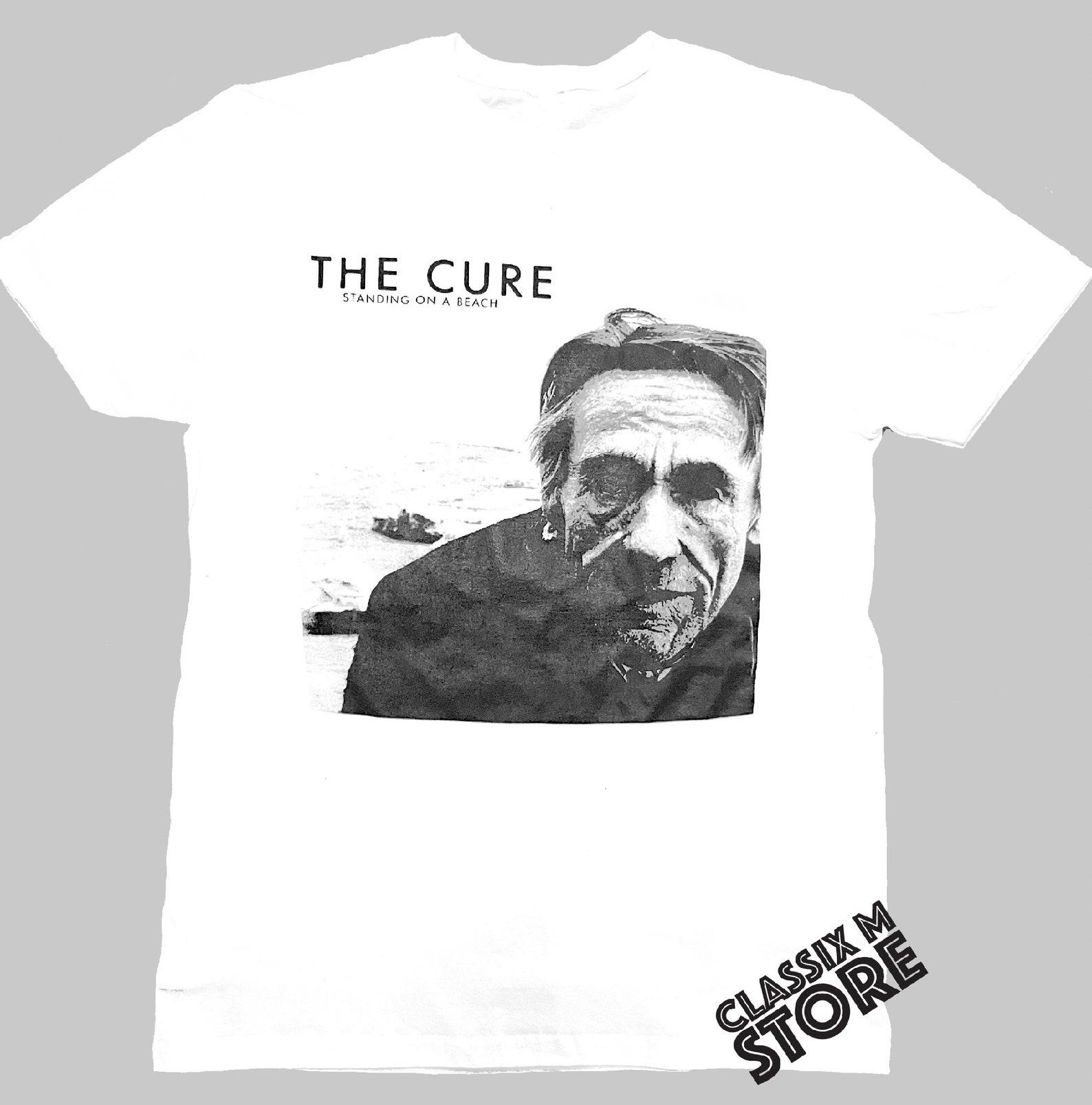 the cure standing on a beach S