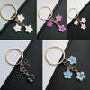 Sakura Oil Drop Keychain – Available in Black, White, Blue, Pink, Purple | Multiple Colors and Metal Parts | Luggage Accessory