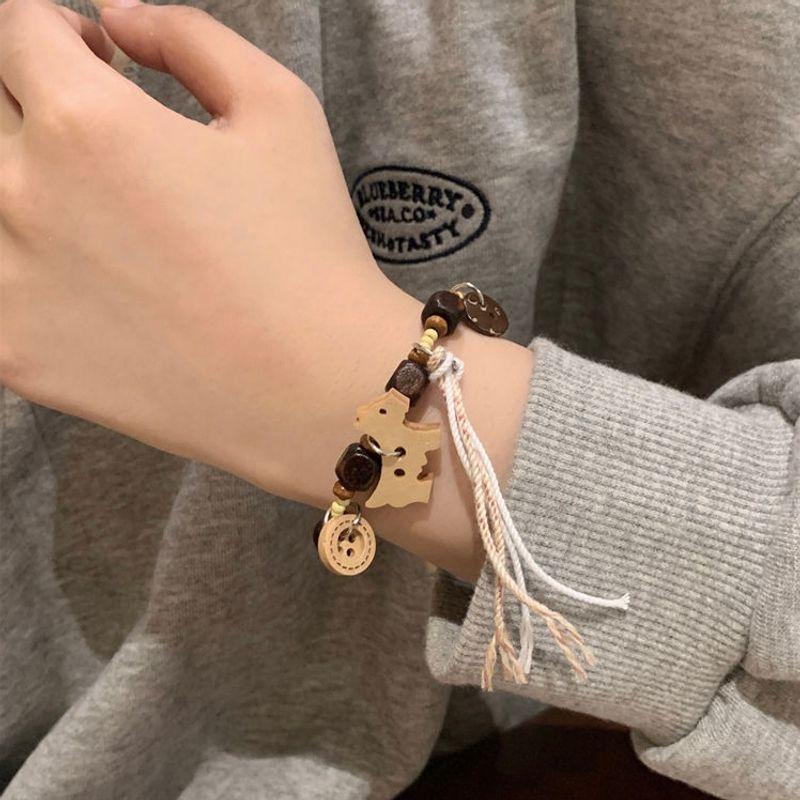 

Новый милый браслет для щенка Новый китайский стиль Плетеный Регулируемый Дизайн с ремешком Чувство Дизайна Подруги Пара Ручные Украшения Браслет Wooden Puppy Tassel Bracelet