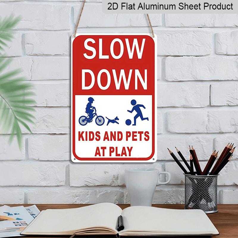 2D Flat Slow Down At Play Metal Sign - Durable Metal Safety Signage, 12*8 Inches, Easy To Install, Red and White with Blue Graphics, Perfect for