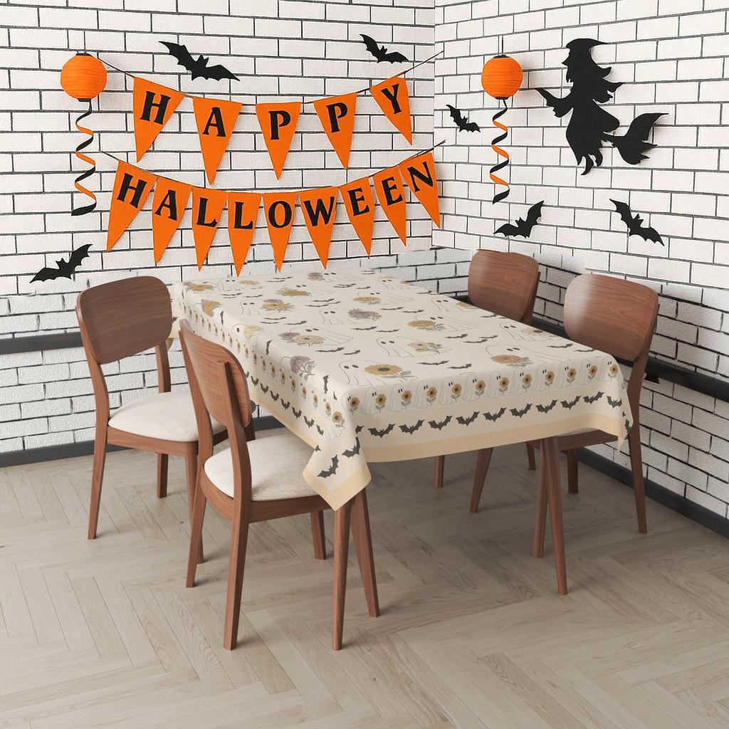A vintage tablecloth with a Halloween theme, featuring ghosts and flowers.