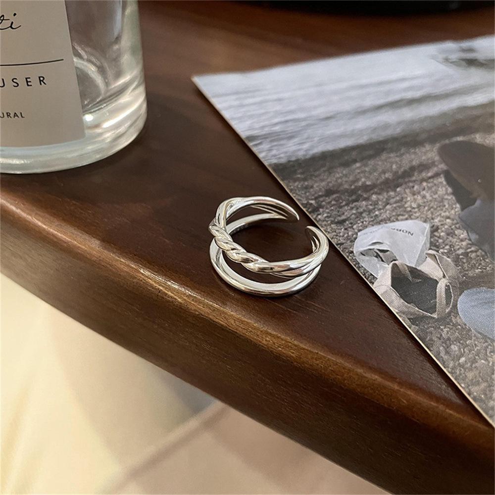

Korean version of simple double-layer twist hollow woven opening ring feeling round brand letter ring