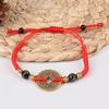 La corda rossa della moneta antica cinese Feng Shui I Ching attira i braccialetti di ricchezza fortunata