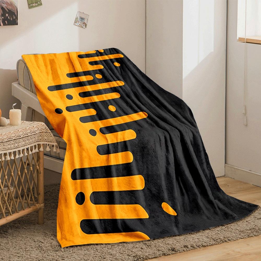 Orange elongated bars and circles merge into a black background diagonally. for all seasons blanket lunch break throw gift