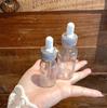 Diamond-Inlaid Frosted Glass Essential Oil Bottle with Rubber Dropper for Serums and Liquid Cosmetics.