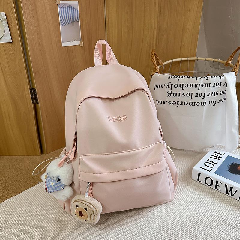 Cream school bag for female junior high school students, high-value niche computer travel backpack, simple and versatile college student backpack