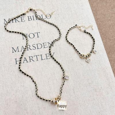 Black Gold Diamond Four-Leaf Flower Necklace & Braided Leather Bracelet for Women - Elegant Chinese Style Fashion