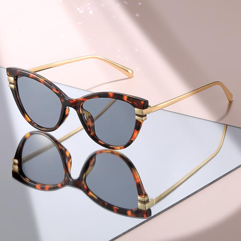 Fashion Cat Eye Sunglasses with Black Top Frame, Red Patterned Lower Frame, Gold Metal Arms, and Gradient Brown Lenses For