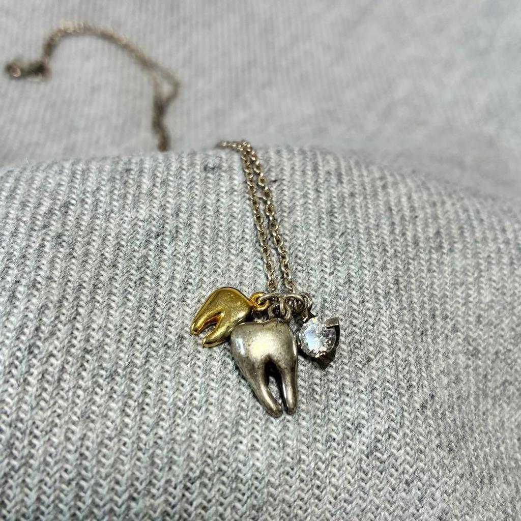 Used Q-pot. Tooth necklace tooth motif