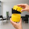 Decorative yellow container with a screw-on lid for small items