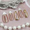 Golden Star Cat Eye Nail Tips: 30-Piece Gilded Exquisite Set with Nude Base Oval Design.